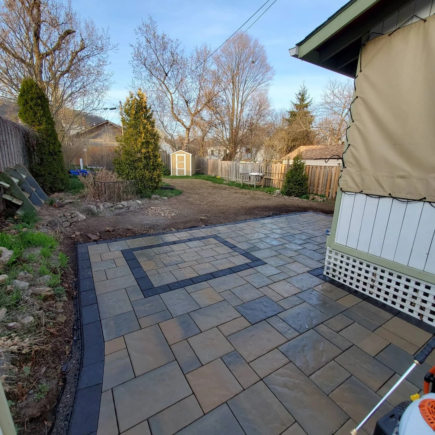 Backyard landscaping in Hamilton with hardscaping patio and sod installation prep