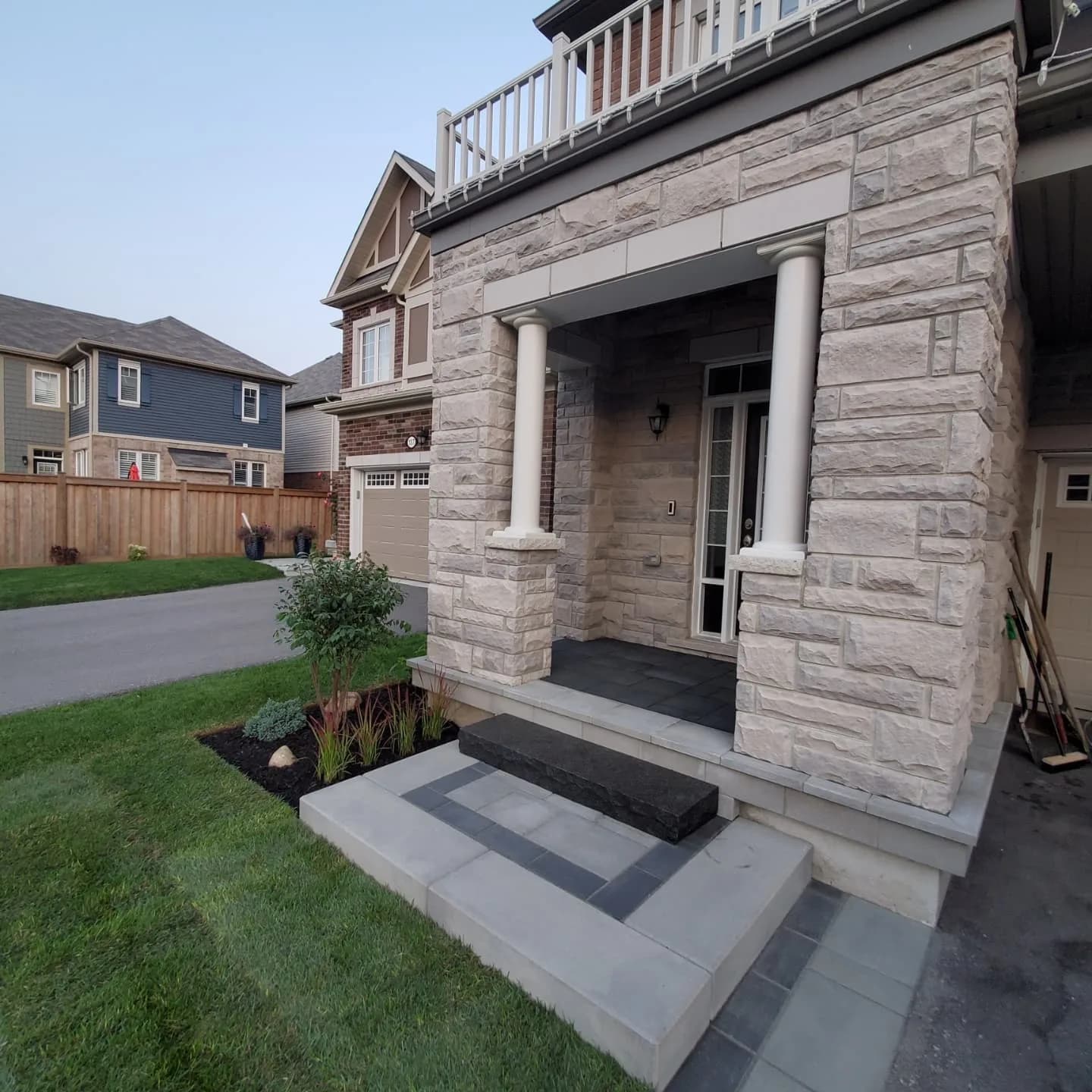 Curb appeal landscaping with interlocking Hamilton walkway, sod installation, and planting beds