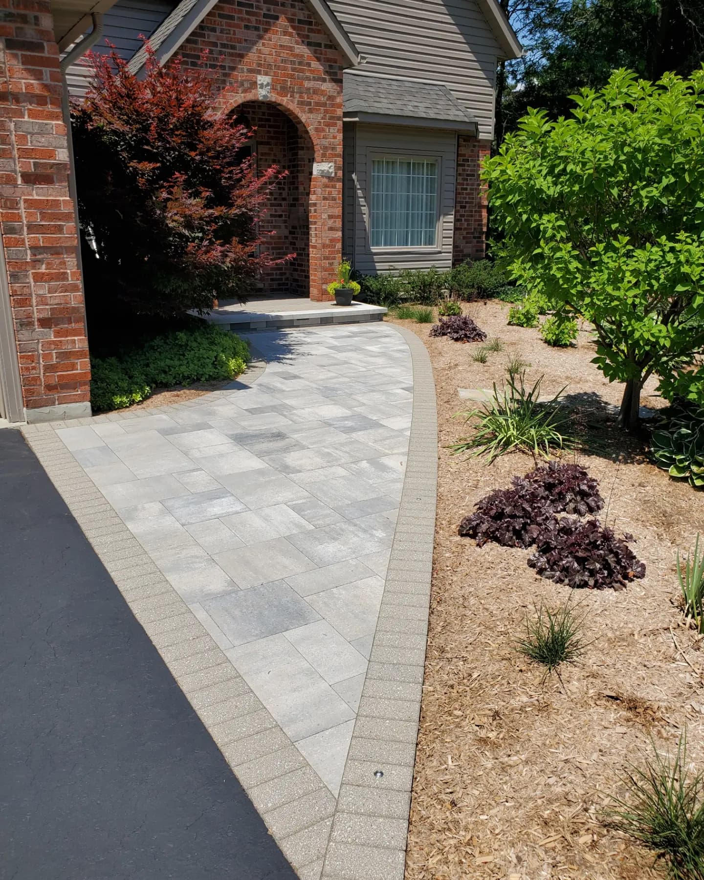 Driveway landscaping with interlocking Hamilton walkway and curb appeal landscaping beds