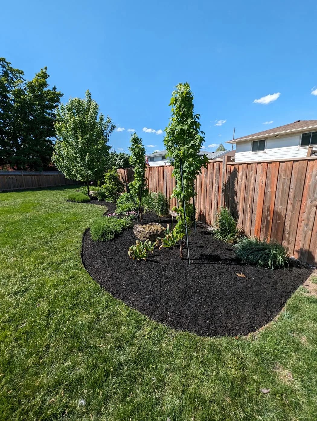 Residential landscaping with planting beds and lawn in Hamilton, Ontario